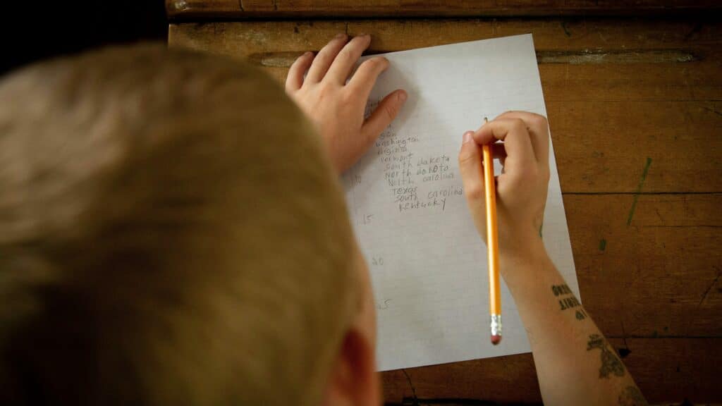 A child writing on Paper. Education