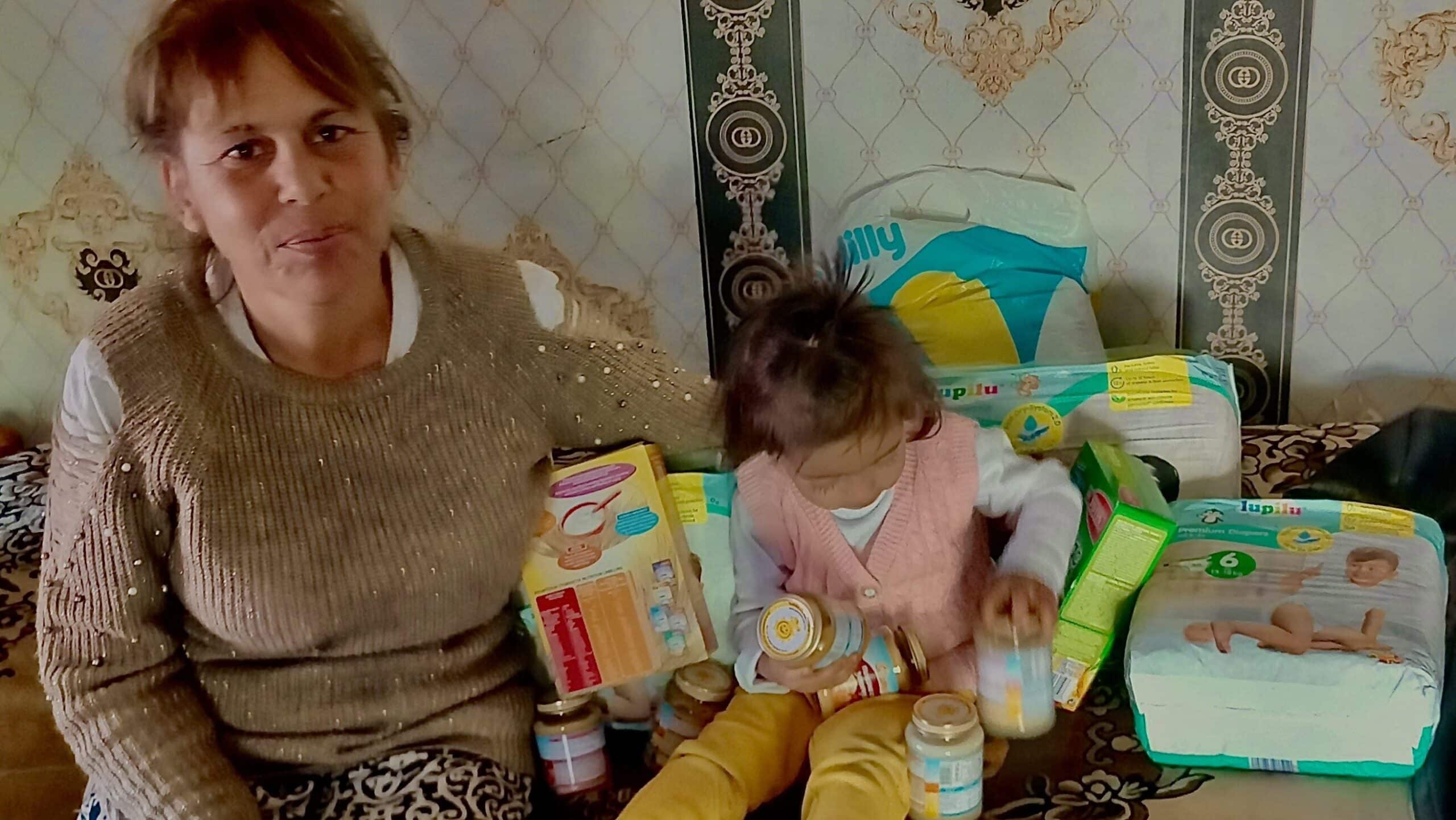 A grandmother, Petya, sits with her granddaughter, Ivanka.