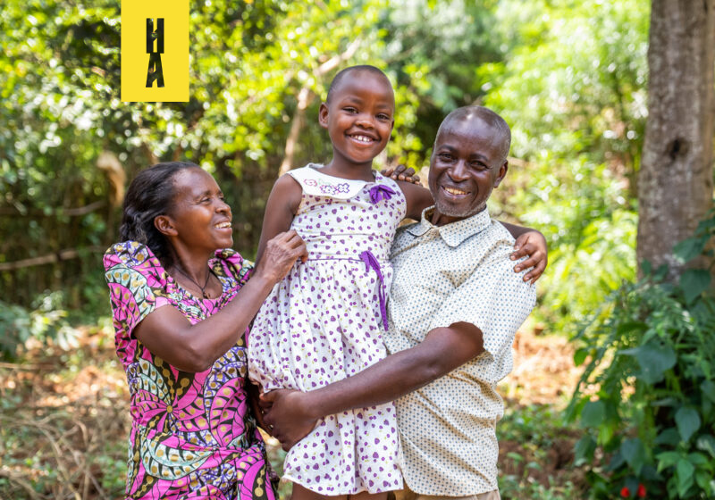 Uwase with her foster mother and father