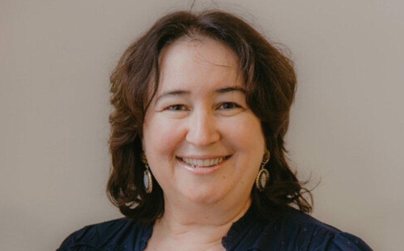 Image is of a woman, Liliana, smiling at camera standing up